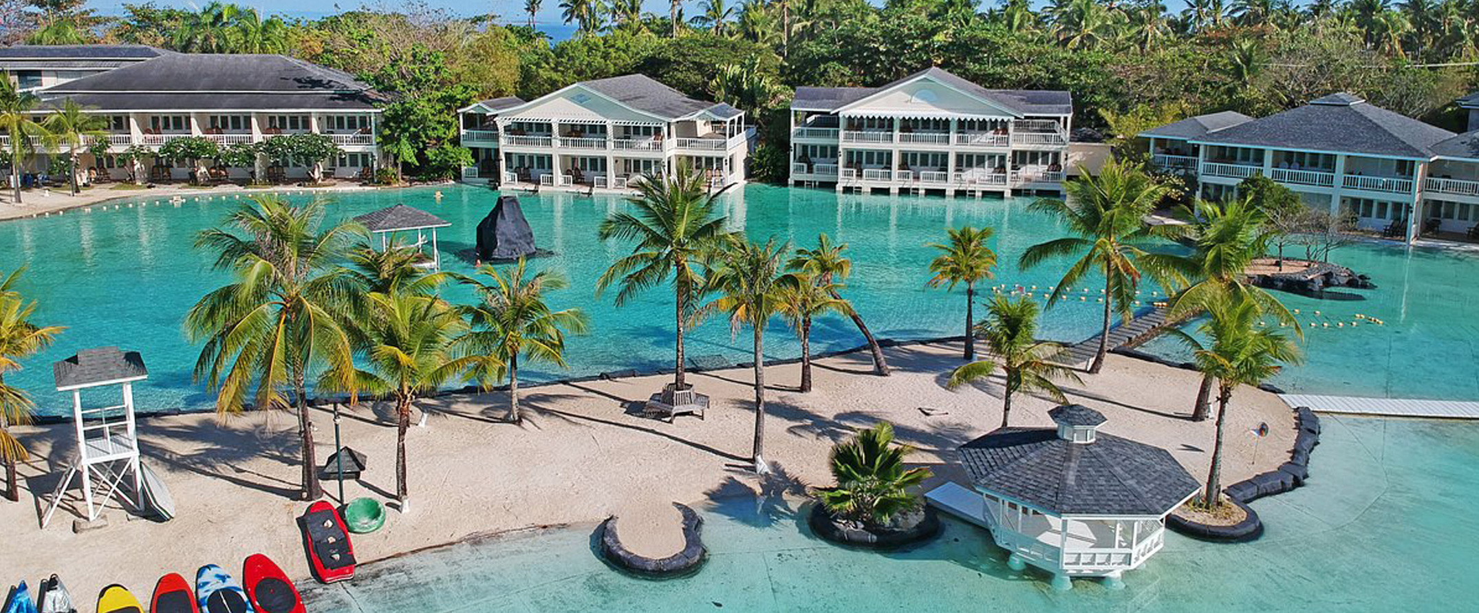 Tropical resort with turquoise lagoon and palm trees